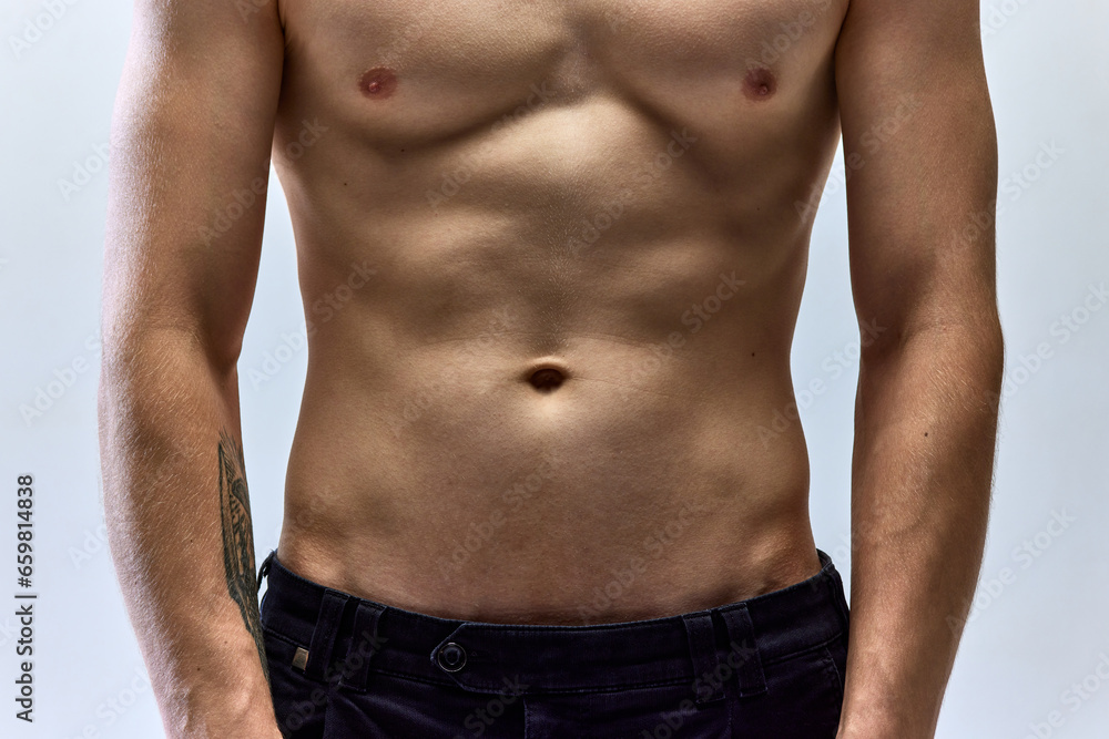 Close up cropped portrait of young male body. Naked bust, stomach, torso of man. Skincare cosmetic treatment affect.