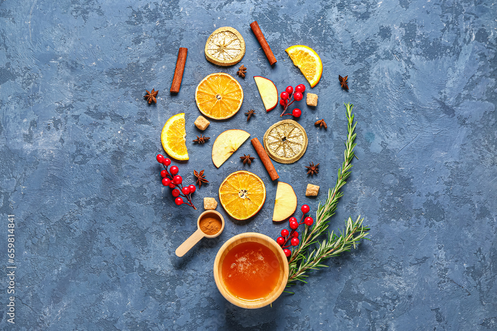 Ingredients for preparing tasty mulled wine and bowl of honey on blue background