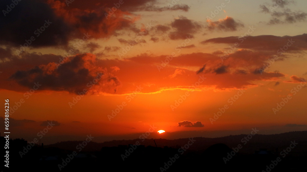 A wide shot of sunset over the areas of Salt and Balqa, west of Jordan, overlooking the Jordan Valley and Palestine, at a time when there were scattered clouds in the sky, and many people believe that A wide shot of sunset over the areas of Salt and Balqa, west of Jordan, overlooking the Jordan Valley and Palestine, at a time when there were scattered clouds in the sky, and many people believe that