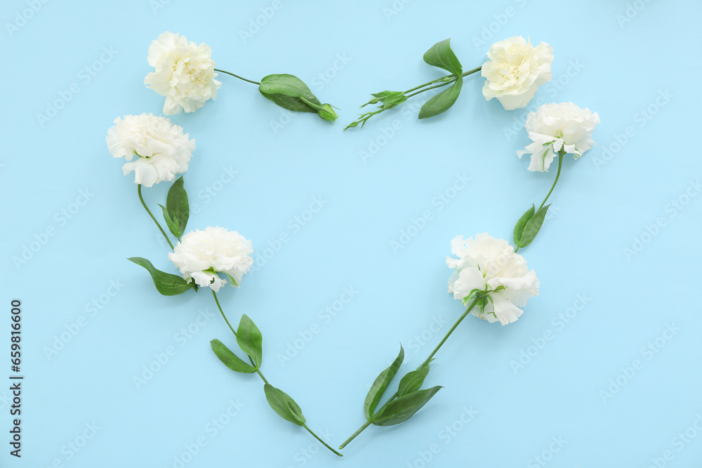 Fototapeta premium Heart made of flowers on blue background. Sweetest Day celebration