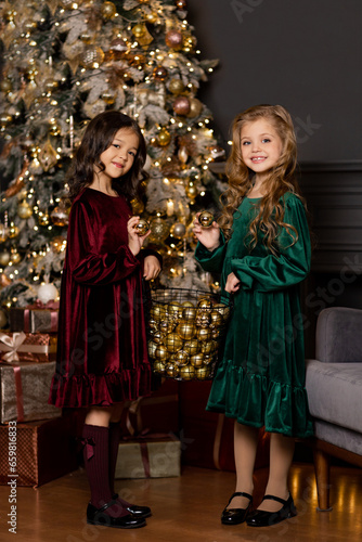 two girlfriends playing with Christmas balls	