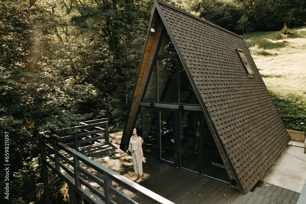 A woman rests and meditates in a house in the forest. Retreat and meditation concept A woman rests and meditates in a house in the forest. Retreat and meditation concept
