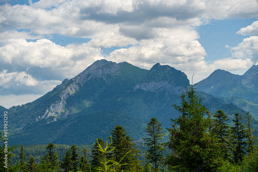 Scenic views from the heart of the Tatra Mountains, featuring the enchanting Polana Rusinowa, the picturesque Gęsia Szyja, and the breathtaking Hala Gąsienicowa. Explore the serene beauty.