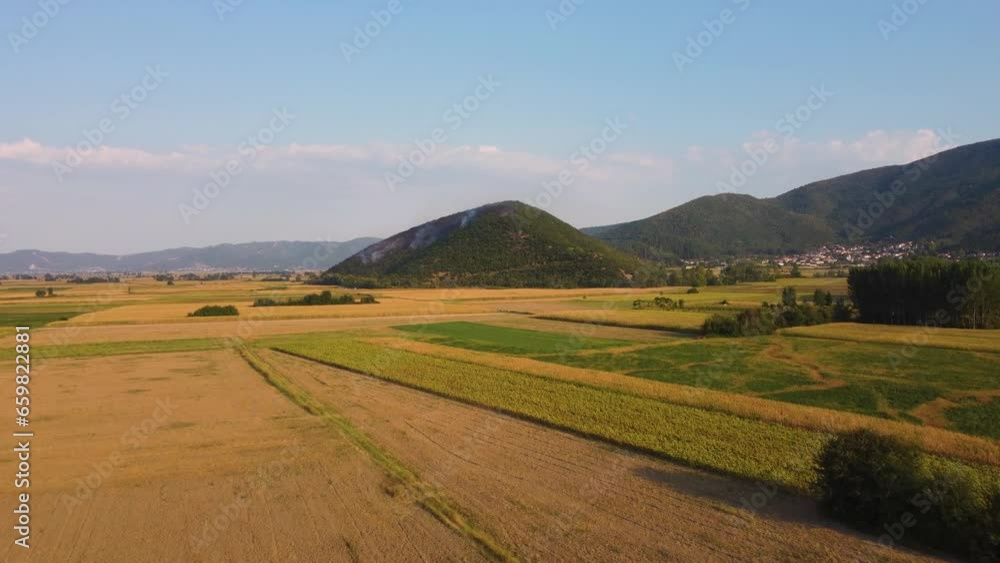 Aerial establishing of wildfire on a hill above agricultural fields in Greece. Aerial establishing of wildfire on a hill above agricultural fields in Greece.