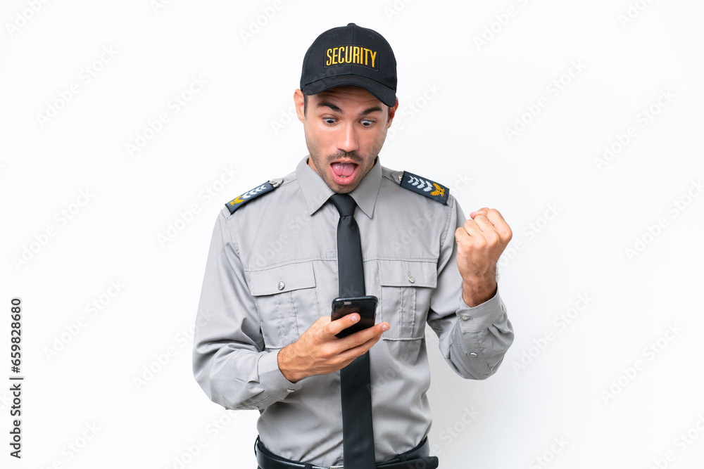 Young safeguard man over isolated white background surprised and sending a message Young safeguard man over isolated white background surprised and sending a message