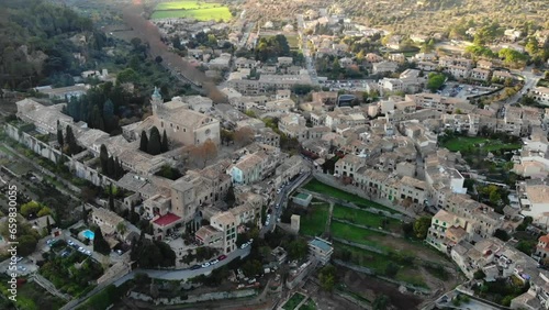 Aerial point of interest shot of Valldemossa village, charterhouse, and picturesque Mediterranean landscape in Mallorca, Spain.