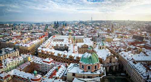 Photography Panoramic winter view of the old town of Prague, with snow covered roof tops of