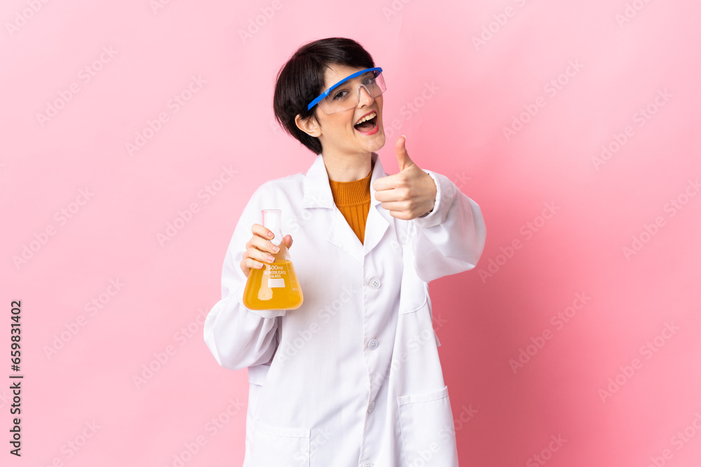 Young scientific woman isolated on pink background with thumbs up because something good has happened Young scientific woman isolated on pink background with thumbs up because something good has happened