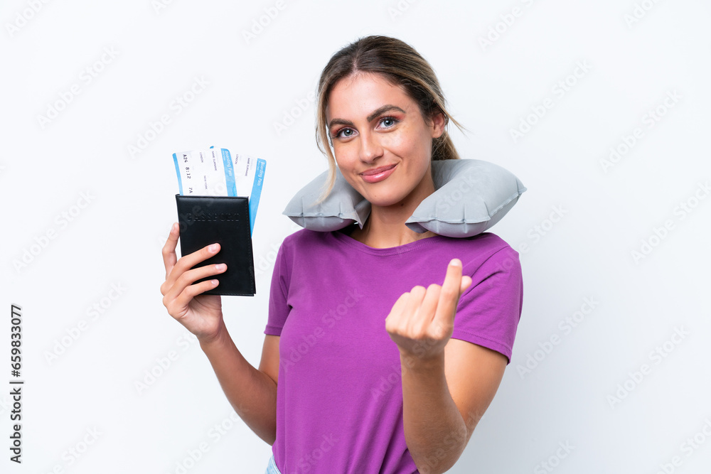 Young pretty Uruguayan woman with Inflatable Travel Pillow isolated on white background making money gesture Young pretty Uruguayan woman with Inflatable Travel Pillow isolated on white background making money gesture