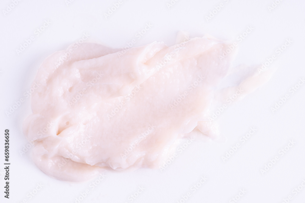 Texture of the light beige cream. White cream smudge swatch textured. Cosmetic smear of creamy texture on a white background Texture of the light beige cream. White cream smudge swatch textured. Cosmetic smear of creamy texture on a white background