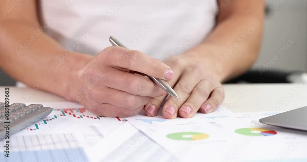 Female hands holding ballpoint pen at table with graphs and diagrams 4k movie. Profit growth business strategies concept Female hands holding ballpoint pen at table with graphs and diagrams 4k movie. Profit growth business strategies concept