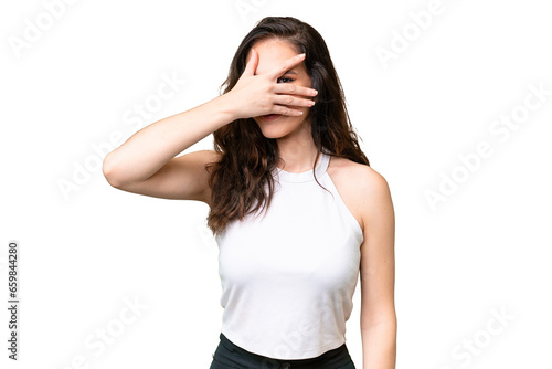 Young caucasian woman isolated over isolated background covering eyes by hands and smiling © luismolinero