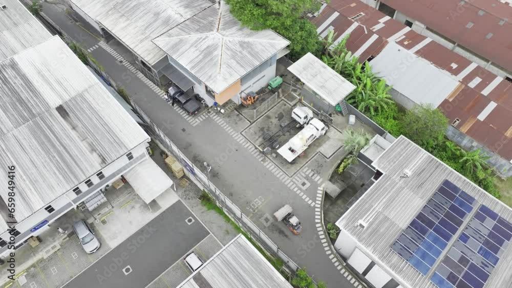 Aerial drone shot (rotating movement): in a sprawling warehouse, forklifts move with agility, optimizing efficiency in the workplace. Daylight. Aerial drone shot (rotating movement): in a sprawling warehouse, forklifts move with agility, optimizing efficiency in the workplace. Daylight.