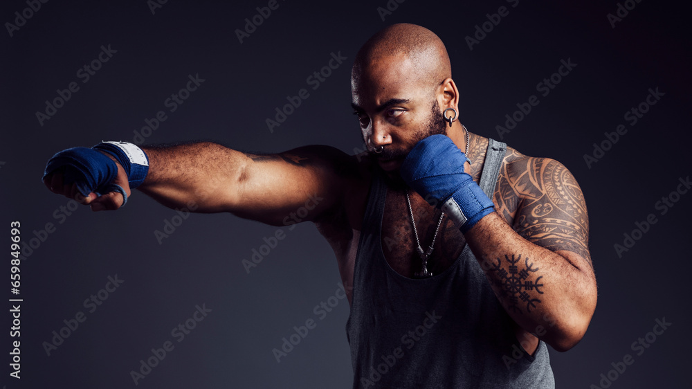 Black man practicing boxing with bandages on hands sore dark background in a studio shot Stock