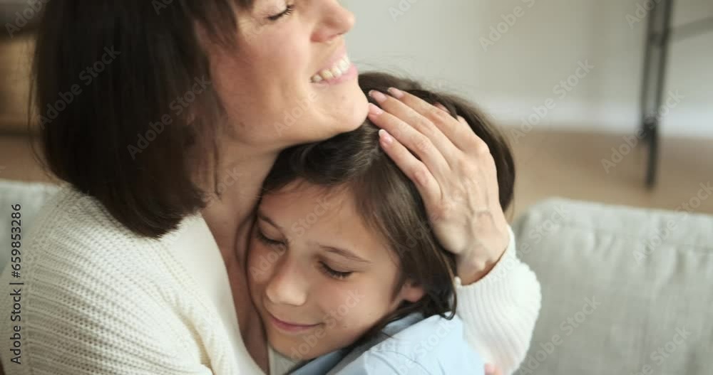 Close up captures the heartfelt embrace between a mother and son in living room sofa. Their love and connection are beautifully expressed in this tender moment. Close up captures the heartfelt embrace between a mother and son in living room sofa. Their love and connection are beautifully expressed in this tender moment.