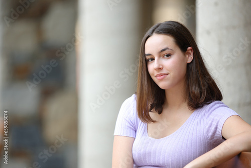 Satisfied woman looks at camera in the street Free Download Satisfied woman looks at camera in the street - GFXLoad
