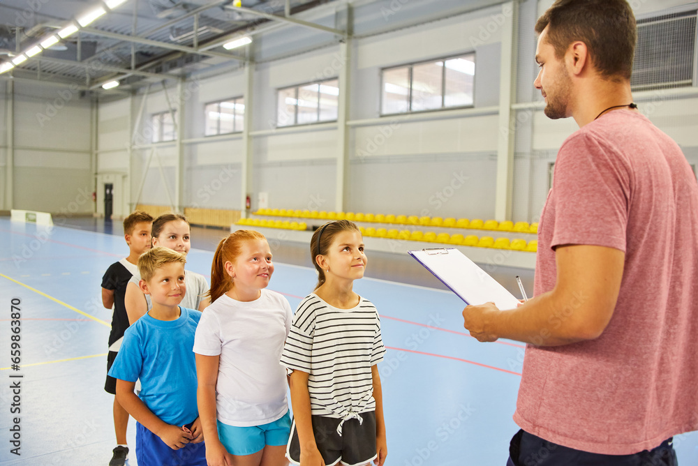 Teacher taking physical test of students during gym class Teacher taking physical test of students during gym class
