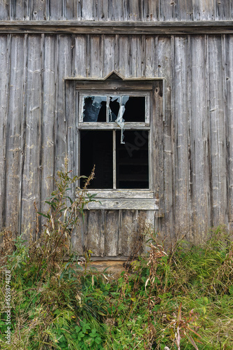 Broken window of an old wooden building in Finland
