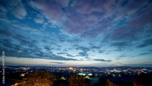 night sky with clouds over a sleeping city time lapse
