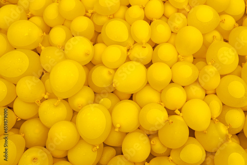 yellow balloons are filled with liquid and lie in the water