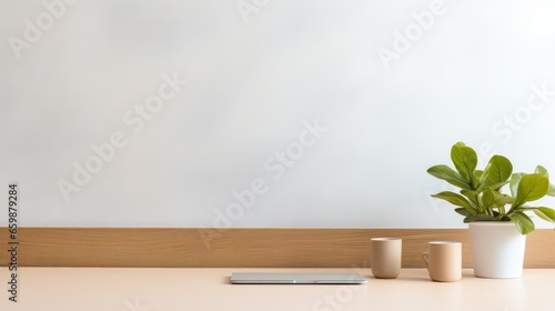 A minimalist office desk bathed in gentle natural light, featuring a laptop.