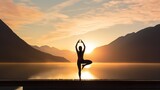 A serene scene captures the silhouette of a woman gracefully practicing yoga at sunrise.