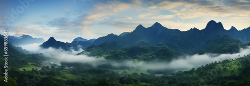 A misty mountain panorama: lush green slopes, peaks shrouded in ethereal fog