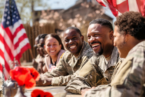Group of happy african american military men, women, war veterans on a sunny day in a street cafe sharing memories and talking about service together. Flag on background. Remembrance, Independence Day photo