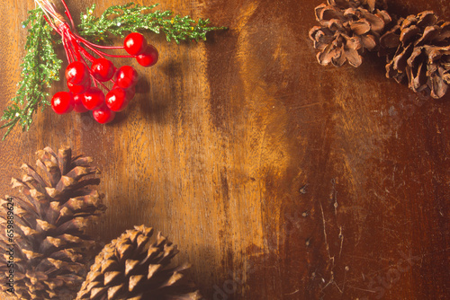 Pine cones red .bead pine needles on wood christmas still life background