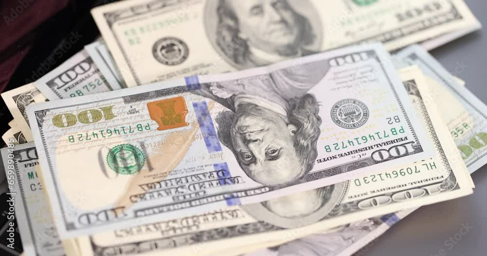 One hundred dollar bills fall on laptop keyboard. Fast money online concept One hundred dollar bills fall on laptop keyboard. Fast money online concept