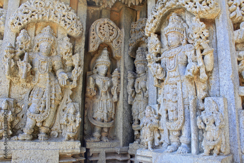 Close up of Deity sculpture under eves on shrine outer wall in the Chennakesava Temple, Hoysala Architecture at Somnathpur, Karnataka, India photo