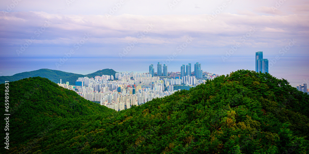 Busan City skyline and apartment buildings over Jangsan Mountains in South Korea