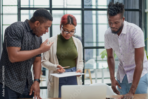 young african american business people in a modern office. © Katsiaryna