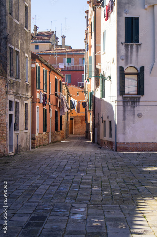Venitian architecture, no one, no people, buildings, daylight. Residential area. Venice, Italy. Old town, facade. Residential neighborhood. Romantic street, clear sky. Drying cloth on a rope. life