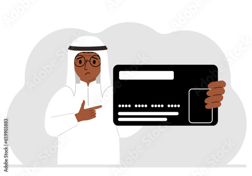 A man holds a large plastic credit card in his hand.