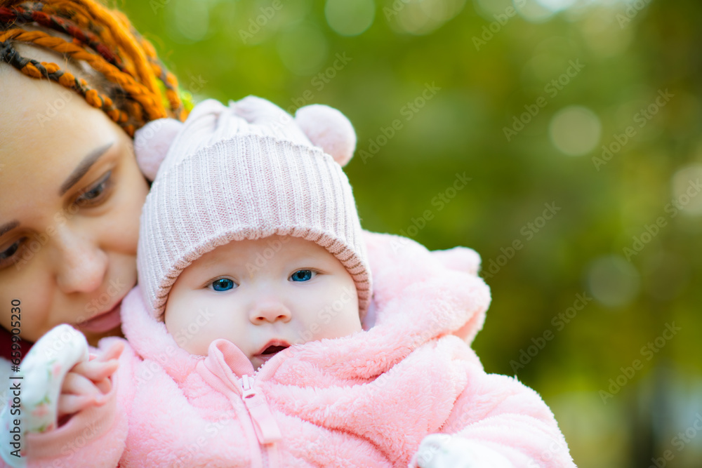 Closeup of mother holding her newborn baby daughter in her arms. Closeup of mother holding her newborn baby daughter in her arms.