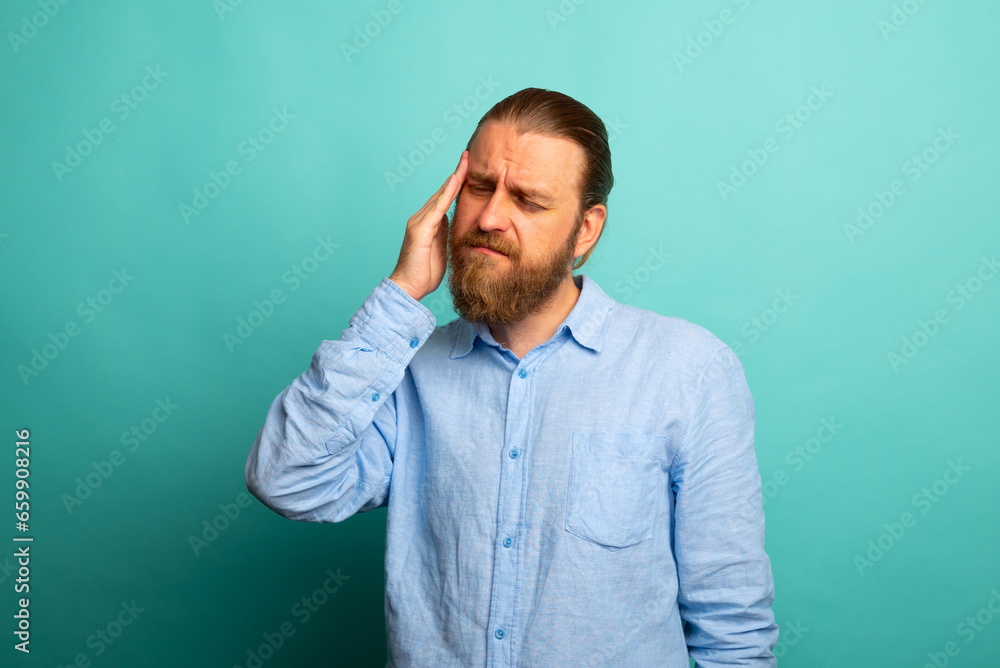 Elegant beard senior man over isolated background with hand on head for pain in head because stress. Suffering migraine.