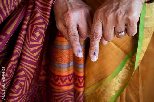 Old indian women showing the ink mark on their fingers after voting, Karnataka, India