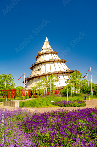 Magdeburg, Germany. Cover page with Japanese garden and science and technology exhibition tower as a cone in the Elbauen city park. Cityscape in the historical downtown photo