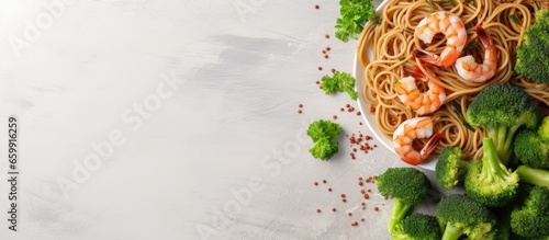 Top view of whole grain spaghetti pasta with shrimp and broccoli copy space available With copyspace for text