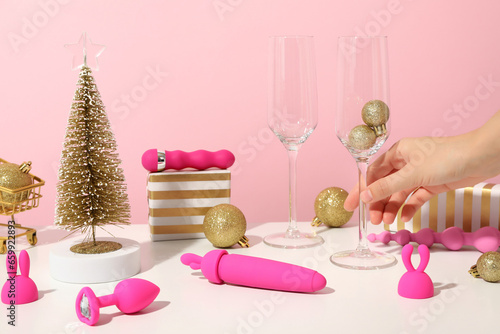 Sex toy with Christmas decor on a pink background.