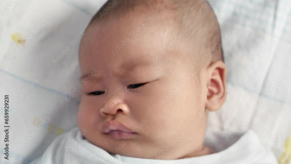 Portrait of cute little Asian newborn baby girl lying down on bed Portrait of cute little Asian newborn baby girl lying down on bed