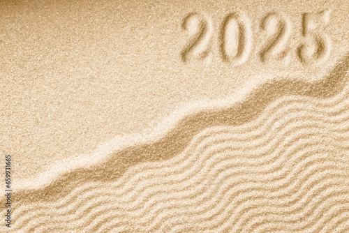 Imprints of numbers 2025 new year on a golden sand waves