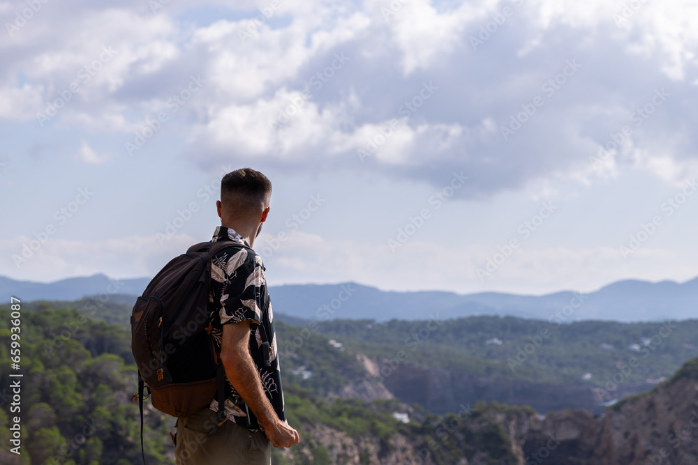 Man looking at the view from the mountain Man looking at the view from the mountain