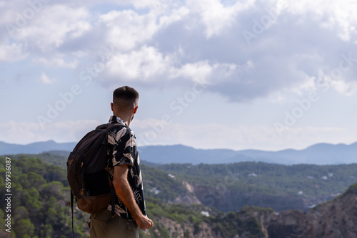 Man looking at the view from the mountain
