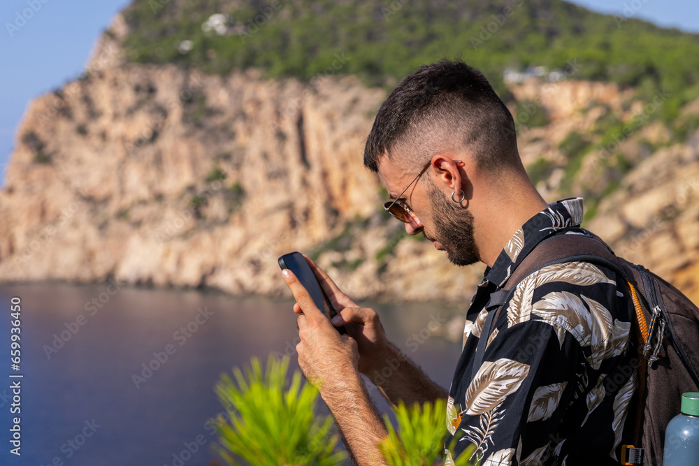 Caucasian man in the mountain using his mobile phone Caucasian man in the mountain using his mobile phone