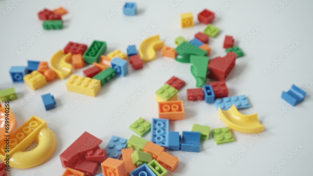 Plastic building blocks on a white background, close-up. Plastic building blocks on a white background, close-up.