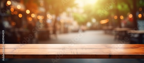 Chose an empty wooden table with a coffee shop background for your photo or product showcase