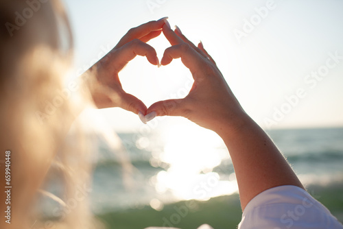 Plus size woman makes heart