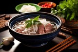 vietnamese pho, with chopsticks and spoon
